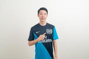 Bangkok, THAILAND - Nov 27, 2021 - Young Asian man wearing Arsenal shirt with white background. photo