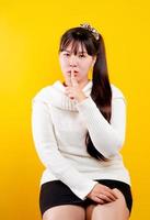 asian girl That cheerful, fun, bright smile. expression of loving eyes good living and happiness at work, relaxation, against a yellow background photo