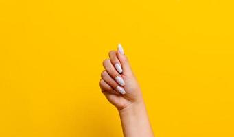 beautiful nail woman Spa manicure and hands close-up beautiful woman hands manicured nails and soft skin wide banner beauty treatment beautiful woman nails with yellow background Beauty concept