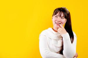asian girl That cheerful, fun, bright smile. expression of loving eyes good living and happiness at work, relaxation, against a yellow background photo