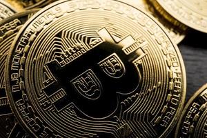 Bitcoin coin the physical bit Digital currency cryptocurrency A gold coin with a gorgeous golden bitcoin symbol. Fit your valuable work. photo