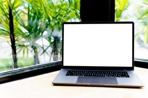 Laptop with blank screen on desk, in office, empty space. concept of working with laptop and working online online communication photo