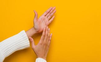 girl on a yellow background Applause after presenting at the meeting congratulation rejoice to oneself and others photo