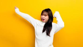 Asian woman sleepy after hard work Workers' sleep problems on a yellow background photo