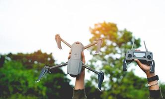 drone and my hand Get ready for an aerial survey flight. and ready for flying high-angle photography photo