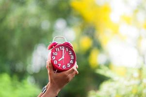 Hands and red clocks photo