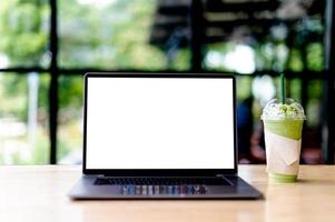 Laptop with blank screen on desk, in office, empty space. concept of working with laptop and working online online communication photo