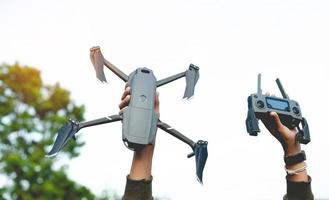 drone and my hand Get ready for an aerial survey flight. and ready for flying high-angle photography photo