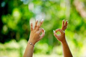 hand gesture ok girl doing okay gesture with her hands understanding of every opportunity that comes and goes photo