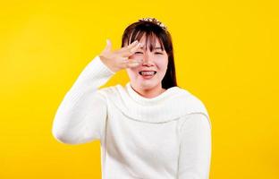 asian girl That cheerful, fun, bright smile. expression of loving eyes good living and happiness at work, relaxation, against a yellow background photo