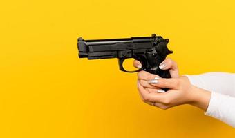 Practice using a gun for self-defense. Asian woman's hand and the guns being trained to shoot to protect themselves from the bad guys in the countryside photo