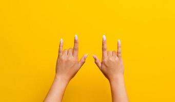 hand expressing love Indication of love. Valentine's Day. Photo on a yellow background.