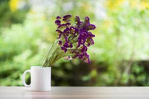 Purple flowers in glass bottles photo