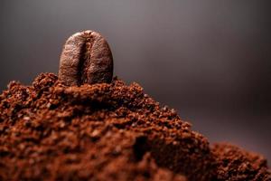 Closeup of coffee beans at the mixed heap of roasted coffee with copy space for text. Concept of Coffee freshness photo