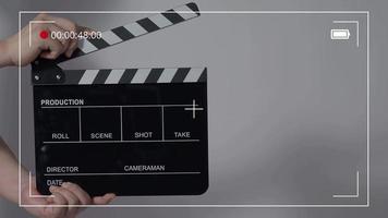 Movie slate or clapperboard hitting. Close up hand holding empty film slate and clapping it. video