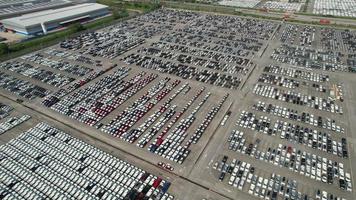 Aerial.new car storage parking lot showing imported new vehicles or ready to export new automobiles storage facility car industry for export all over the world market for car sales