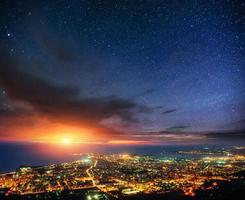 Fantastic views of the starry night sky above the city photo