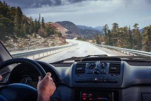 car on the road leading to the mountains photo