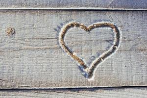 Writing on the snow. Wooden texture. photo