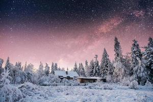 chalets in the mountains at night under the stars. photo