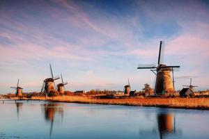 The road leading to the Dutch windmills from the canal photo