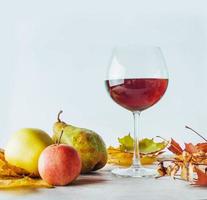 Autumn still life. Golden leaves a apples and pears photo