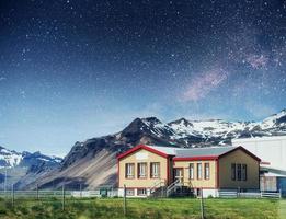 chalets in the mountains at night under the stars. photo