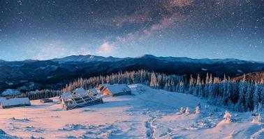 chalets in the mountains at night under the stars. Carpathians, photo