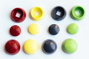 Colored plastic caps isolated on white background photo