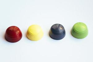 Colored plastic caps isolated on white background photo