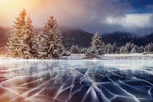 Blue ice and cracks on the surface of the . photo