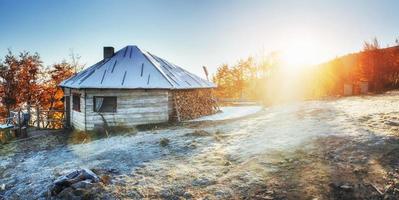 Cabin in the mountains in winter. Mysterious fog. photo