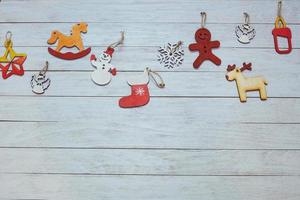 Christmas ornaments and garland lights on wooden white backgroun photo