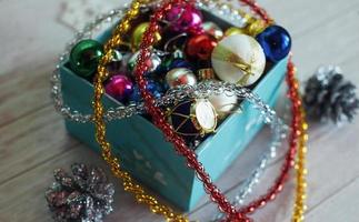 Paper box filled with colorful Christmas decorations, isolated o photo