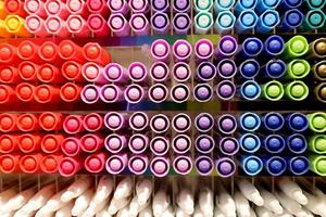 background of Colorful markers on shelf in stationery store. Colored pens on shelves In the shop. Colorful pens arranged. photo