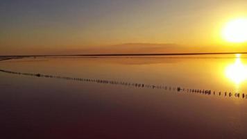 Beautiful Sunset lake landscape. Romantic pink sunset sky. Breathtaking view of sky reflection in salt lake photo