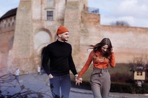 Young couple in love outdoor.Stunning sensual outdoor portrait of young stylish fashion couple posing in summer in field. couple walking in the city. selective focus photo