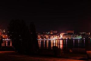 Panorama of night city lights and reflections on lake at Ternopil, Ukraine, Europe. photo