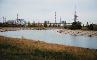 Chernobyl alienation zone. View of Chernobyl atomic plant background river. photo