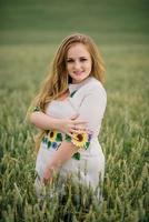 Young girl at ukrainian national dress posed at wreath field. photo