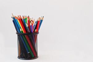 Colored pencils in black pencil case  isolated on white background.