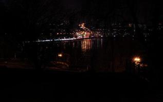 Panorama of night city lights and reflections on lake at Ternopil, Ukraine, Europe. photo