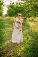 Young girl at ukrainian national dress posed at spring garden. photo