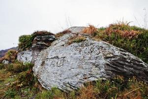 Big rocky stones at the foot of the mountain photo