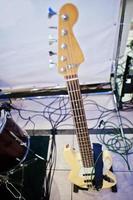 Fretboard of electric bass guitar on stage. photo