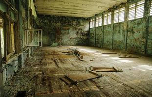 Lost school sport gym at Chernobyl city zone of radioactivity ghost town. photo