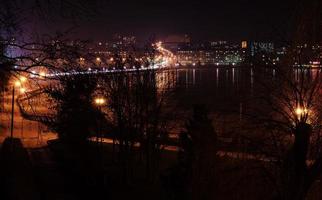 Panorama of night city lights and reflections on lake at Ternopil, Ukraine, Europe. photo