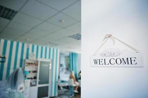 Wooden welcome sign blue beauty salon background photo
