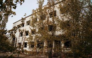 Chernobyl exclusion zone with ruins of abandoned pripyat city zone of radioactivity ghost town. photo