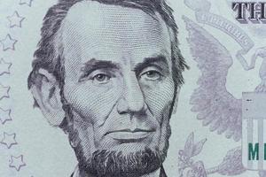 US President Abraham Lincoln face on five dollar bill macro, 5 u photo